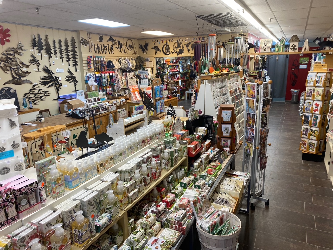 Interior of a garden and giftware store with different merchandise on display on floor stands and on the walls.