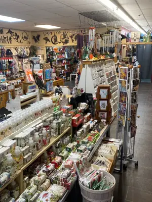 Interior of a garden and giftware store with different merchandise on display on floor stands and on the walls.