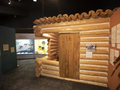 Log cabin display as part of an exhibit in a museum