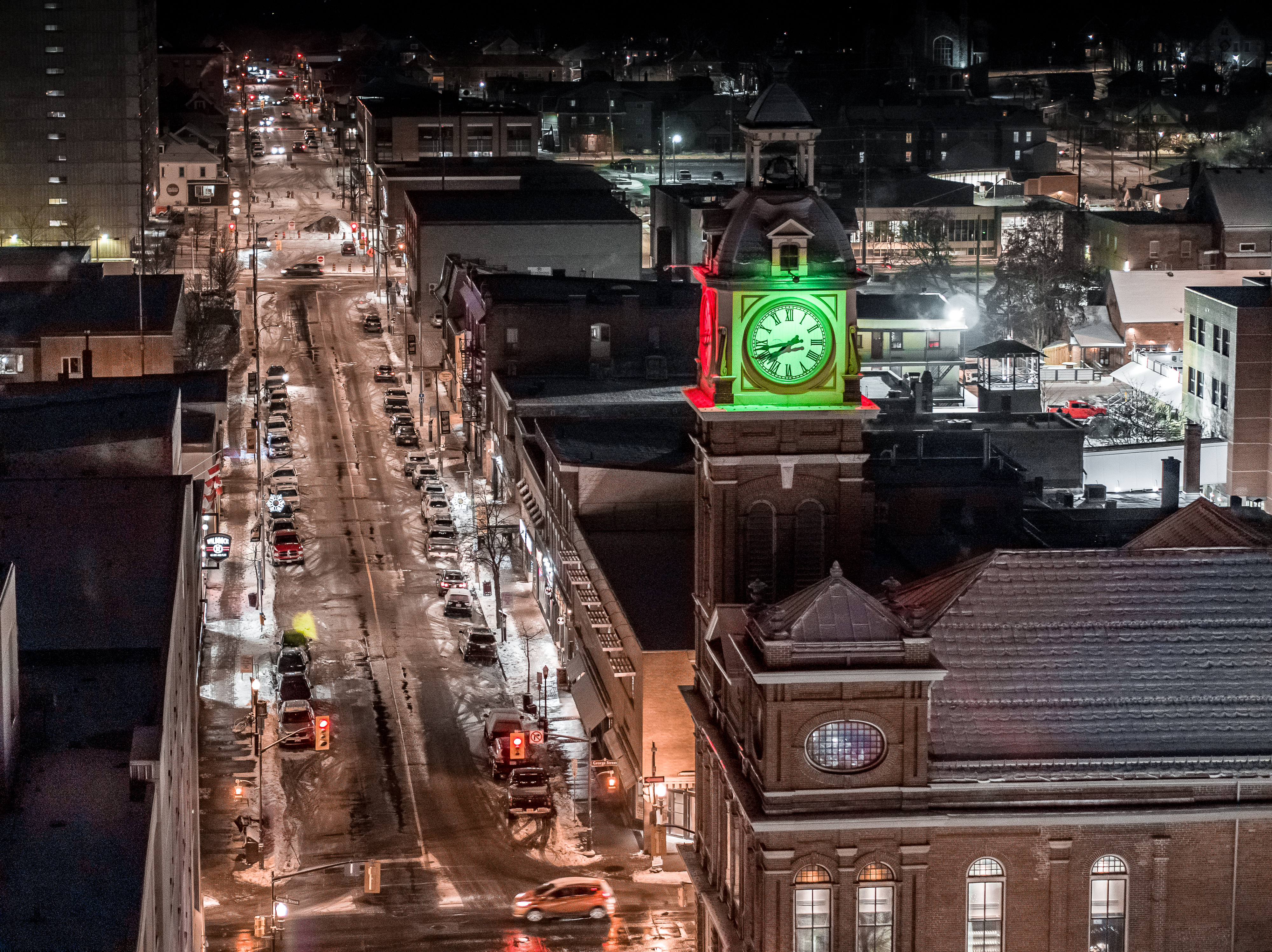 Drone image with the Market Hall Clock Tower in the foreground and winter time imagery of George Street in Peterborough